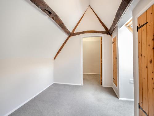 an empty hallway with an open door in a house at Greenhill Farmhouse in Bletchingdon