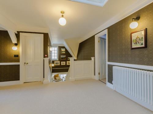a hallway of a home with a door and a staircase at West Bay House in Westgate-on-Sea