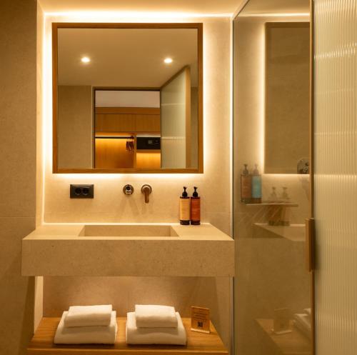 a bathroom with a sink and a mirror at Mitsis Bali Paradise in Bali