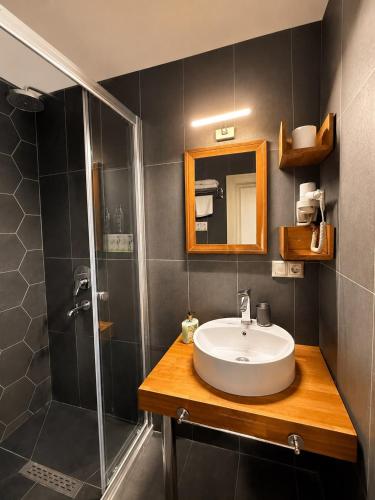 a bathroom with a sink and a shower at Kuzen Otel in Istanbul