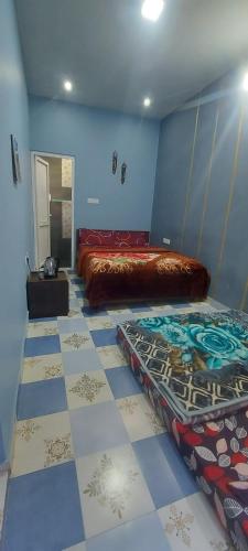 a bedroom with two beds and a tiled floor at Steep Valley Resort in Kotagiri