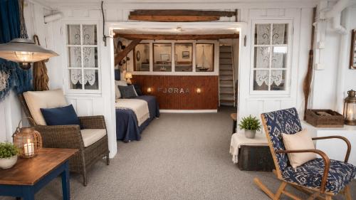 a room with a bed and a couch and a table at Sjøhuset Sjøholt in Sjøholt