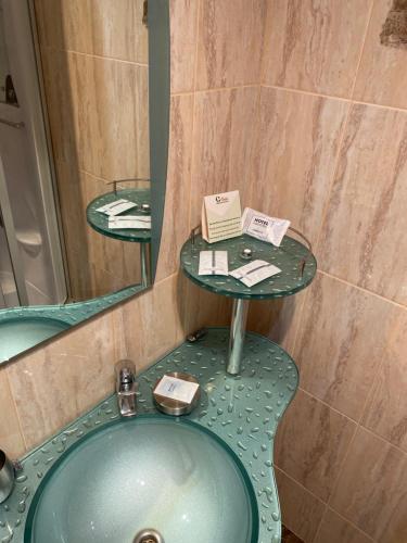 a bathroom with a sink and a mirror at Stizhok Hotel & Restaurant in Berkhomet-pe-Siret