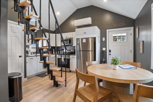 a kitchen and dining room with a table and chairs at Pelican Cliff Cottage - Tiny Home at Hampton Beach in Hampton