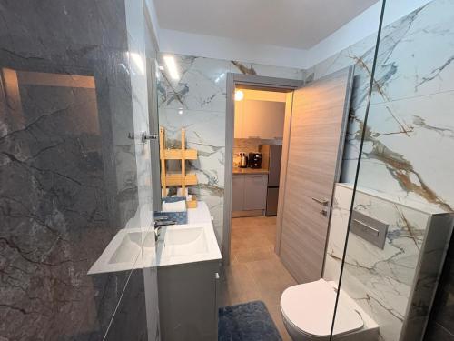 a bathroom with a shower and a toilet and a sink at Viasol Suites Thassos in Skala Rachoniou