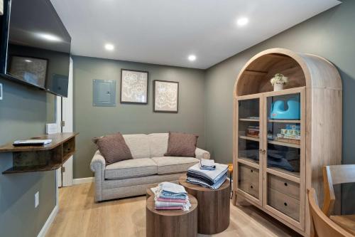 a living room with a couch and a chair at Sandy Toes Cottage - Tiny Home at Hampton Beach in Hampton