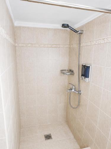 a bathroom with a shower with a shower head at Angels' House in Thessaloniki