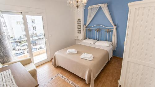 a bedroom with a bed with two towels on it at Angels' House in Thessaloniki