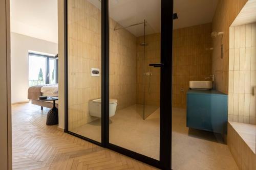 a bathroom with a glass shower and a toilet at Persolis luxury sun residence in Kojsko