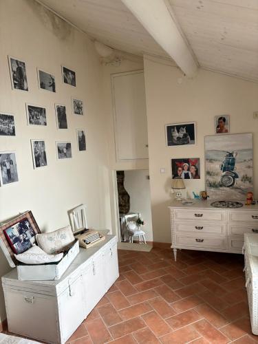 a living room with a couch and pictures on the wall at Casa da Antonia 850 ASL in Ronchi