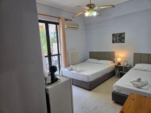 a hotel room with two beds and a window at Elea rooms 7 in Elia Laconias