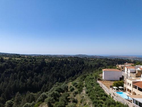 a view from the top of a building with trees at Ilys Home, a Country-chic Retreat with Pool & BBQ, By ThinkVilla in Margarítai