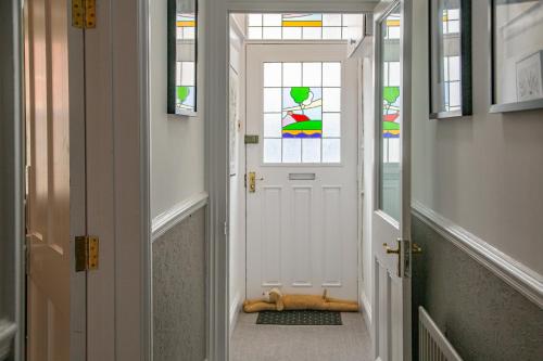 a hallway with a white door with a stained glass window at Hudson House in Durham