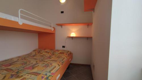 a small bedroom with a bed in a room at Fausta Lago in Colico