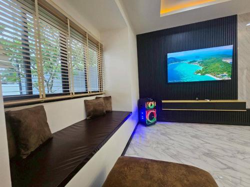 a room with two chairs and a flat screen tv at 185 HomeStay Chiangmai 185 โฮมสเตย์ เชียงใหม่ in Hang Dong