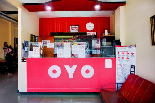 a store front with a red and white sign at Collection O Banda Aceh near Masjid Raya Baiturrahman formerly Hotel Mulana in Banda Aceh