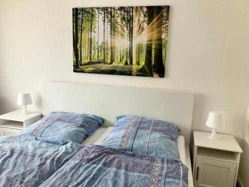a bedroom with a bed and two night stands with lamps at Appartement Scharf in Bad Harzburg