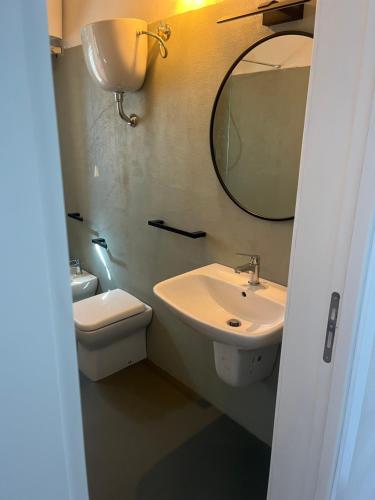 ein Badezimmer mit Waschbecken, Spiegel und Toilette in der Unterkunft al numero zero in Lipari