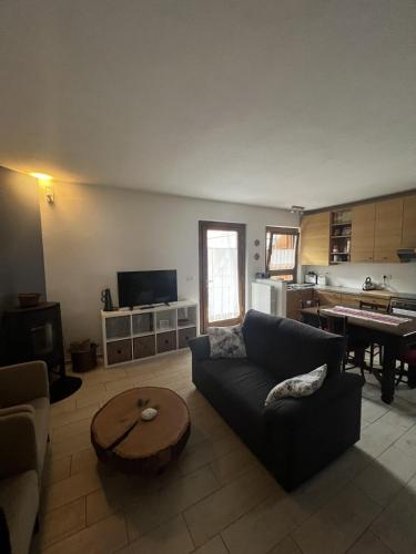 a living room with a couch and a table at Casa Balzarini- Vecchio Mulino in Entracque