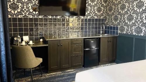 a kitchen with a sink and a counter top at Midnight Sun, a Coast Hotel in Dawson City