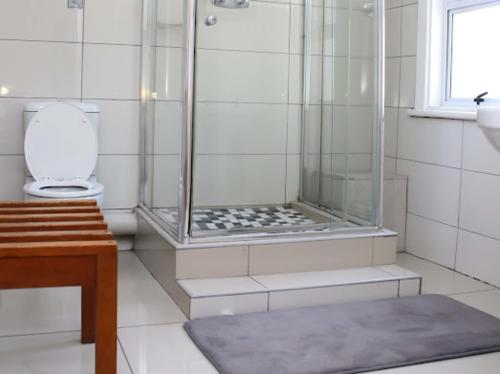 a bathroom with a shower and a toilet at Park Hotel Bethlehem in Bethlehem