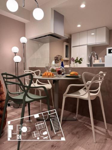 a kitchen with chairs and a table and a counter at LinksHotel高円寺 in Tokyo