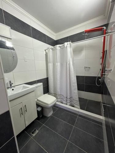 a bathroom with a toilet and a sink and a shower at Yaque Land in El Yaque