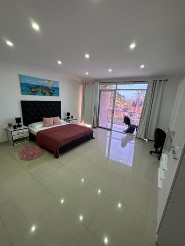 a bedroom with a bed and a large window at Yaque Land in El Yaque
