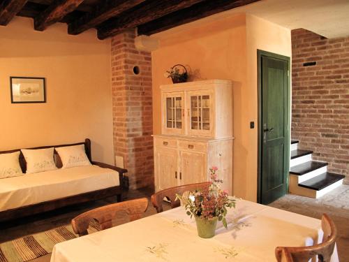 a bedroom with a bed and a table with flowers on it at Stone House Pojata in Starigrad-Paklenica