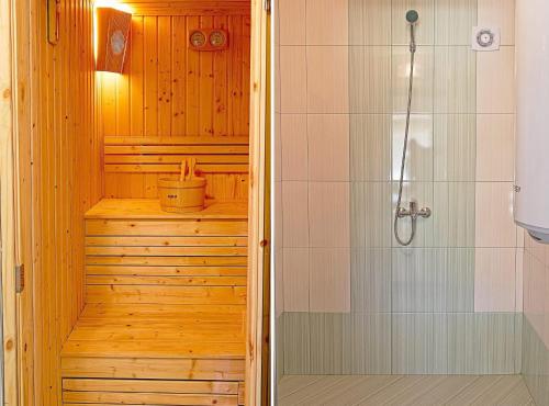 a bathroom with a shower and a walk in shower at Forest Hills in Kovačevica
