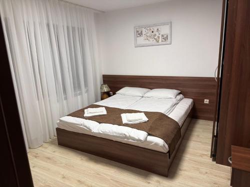 a bedroom with a bed with two towels on it at Forest Hills in Kovačevica
