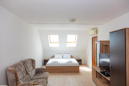 a living room with a bed and a couch at Антична панорама in Hisarya