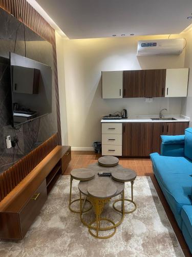 a living room with a blue couch and a table at شقق احد رفيدة in Ahad Rafidah
