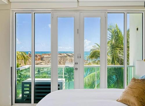 a bedroom with a view of the ocean at Designer Oceanview Penthouse & Pool - Condado in San Juan