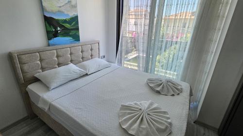 a bedroom with a bed with a large window at Villa Zümrüt in Ortaca