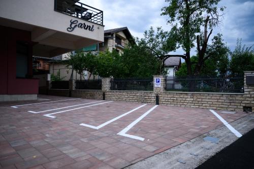 an empty parking lot in front of a building at Pansion Garni in Bihać