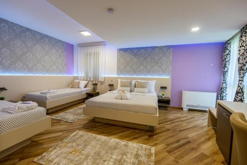 a bedroom with two beds and a couch at Pansion Garni in Bihać
