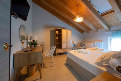 a bedroom with a bed and a desk with a mirror at Ca' Lodola in Borzano