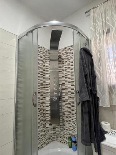 a shower with a glass door in a bathroom at Casa Vacanze PIAZZETTA in San Nico