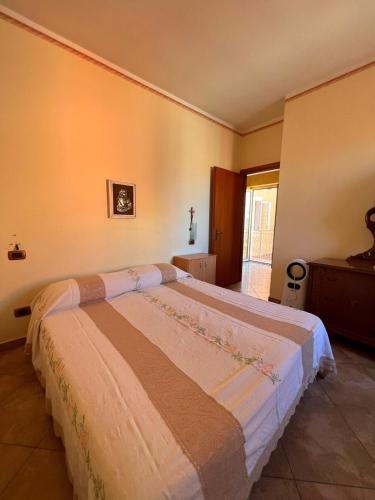 a bedroom with a large bed in a room at Casa Vacanze PIAZZETTA in San Nico