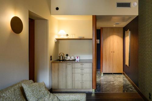 a living room with a couch and a kitchen at Hotel Frihavnen in Copenhagen