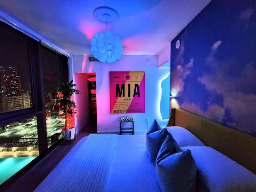 a bedroom with a bed with a mma sign on the wall at Electric Luxury Downtown Bayfront Brickell in Miami