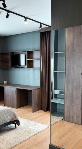 a bedroom with a desk with a microwave and a tv at Villa Blanc in Bukovel