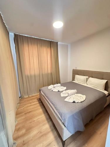 a bedroom with a bed with two towels on it at Flamingo Vacation Rentals in Paphos