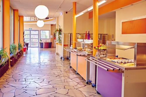 a large kitchen with a long hallway at DJH Jugendherberge Hagen in Hagen