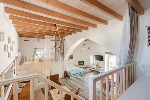 a living room with wooden ceilings and a staircase at Stefanis Relis House in Archangelos