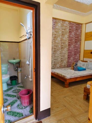 a room with a bathroom with a sink and a toilet at Sagada Staycation with Mountain View! in Sagada