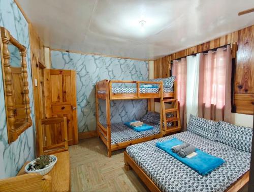 a bedroom with two bunk beds in a room at Sagada Staycation with Mountain View! in Sagada