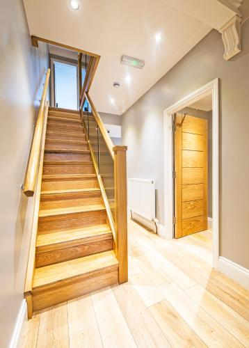 a staircase in a house with wooden floors at Dolphin Rooms in Cleethorpes