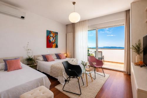 a bedroom with two beds and a view of the ocean at Terra Magica Deluxe Sea View Apartment or Room with Free Parking in Rijeka